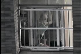 Sexy naked neighbor is staying in front of the open window
