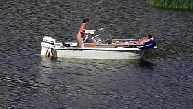 Nudist couple has fun in the middle of a beautiful lake