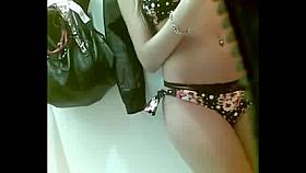 Teen in dressing room wearing swimsuit 2