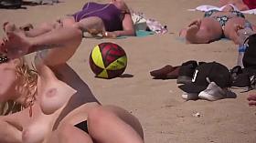 Fit topless blonde with hot natural tits on the beach !