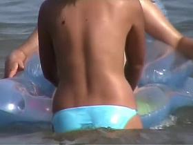 Amateur beach girls voyeured topless in the water