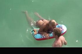 Topless chick with small boobs in the water