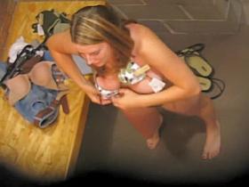 Fem trying on bra before changing room mirror