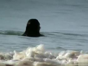 Milf with saggy tits goes skinny dipping in the ocean