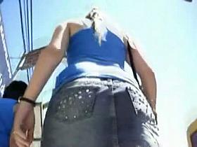 Sexy ponytail girl in blue athletic shirt filmed by a voyeur