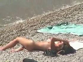 Muscular men and sleek women on a nude beach candid video