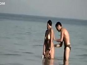 Dude playing around with a topless girl