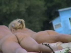 Hot blonde gets naked at the beach for nudists