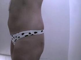 Woman showering and dressing in beach cabin