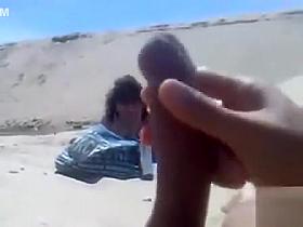 Masturbating to a stranger on the beach
