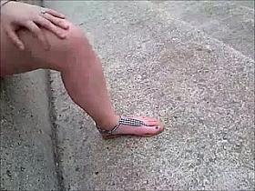 Slutty girl flashes her slit in the open and masturbates