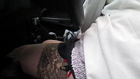 Girl in stockings and black leather boots in a car