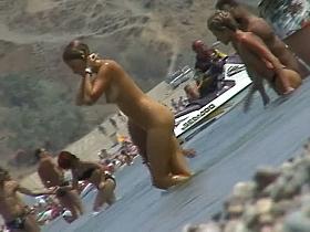 lots of very sexy naked babes on the nudist beach getting wet