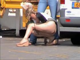 Kinky babe pissing in the public and voyeured on cam