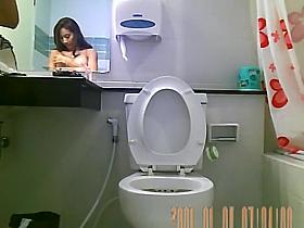 Sexy hot brunette spied in bathroom peeing