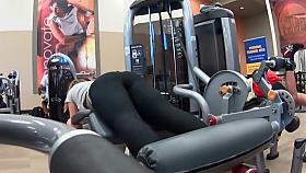Sexy girl does leg curls in gym