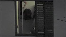 Two voluptuous stunners try out clothes by the window