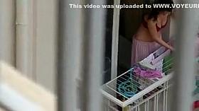 Lovely neighbor girl is hanging clothes