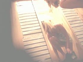 Voyeur hunter admires slim blonde in the changing room