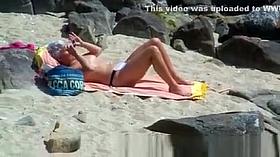 Oiling milf on the beach