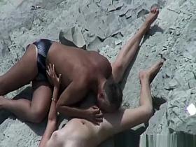 Older man licks pussy in beach