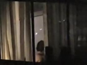 Dark haired female spied nude by the kinky neighbor