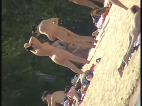 Smooth ass babes on the beach are showing their boobies