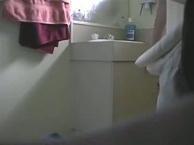 A sexy athlete girl takes a shower voyeur video