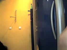 Chubby brunette undressing in tanning room