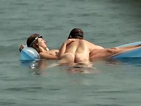 Couple plays around on an air mattress