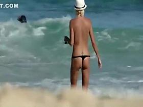 Skinny topless girl enters the water