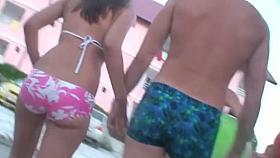 Beach voyeur spying on a woman walking around in her tight bikini