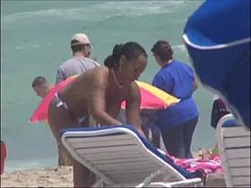 Plump breasted girl caught in a voyeur beach nudism video