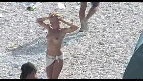 Voyeur on public beach. Funny dancing