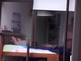 Mature spied through the hotel bedroom window