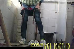 Asian girl pulls down her tight jeans to pee