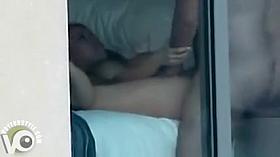 Our neighbors caught having sex through a hotel window