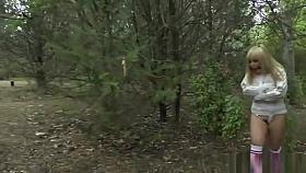 Gagged blonde in strait jacket in public