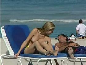 Topless beach voyeur shots of cute girls relaxing themselves