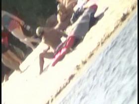 a voyur porno of a sexy blonde chick sitting tanning on a beach