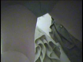 Nude girl in dressing room bends over searching the cloths