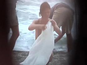 Sexy woman getting a beach massage