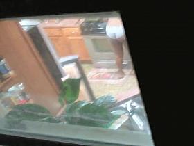 Black amateur walks around the house with her saggy tits out