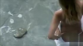 Beautiful bare girls pose for photos at the beach