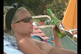 Hot video of a mature woman reading a book on a nudist beach