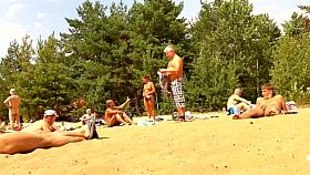 Wives and their husbands sunbathing at the nudist beach