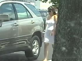 A sexy middle aged woman in a tight white dress voyeur video