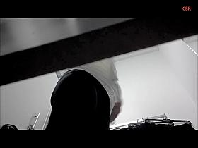 Golden hair mature is trying on new shirt in the change room