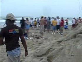 Happy girls show off their wares at a beach party