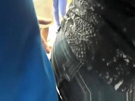 Guy gropes woman's ass in tight jeans pants